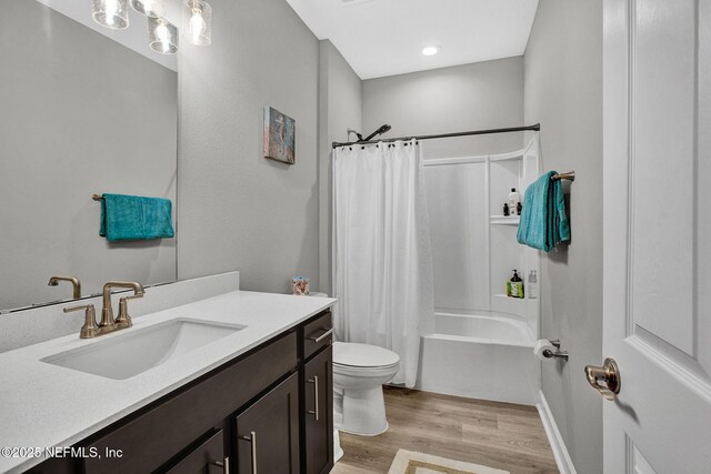 267 Honeycomb Trl, Saint Augustine, FL 32095 - bathroom with wood finished floors, toilet, vanity, and shower / bathtub combination with curtain