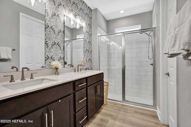 267 Honeycomb Trl, Saint Augustine, FL 32095 - bathroom featuring a stall shower, double vanity, and wood finished floors