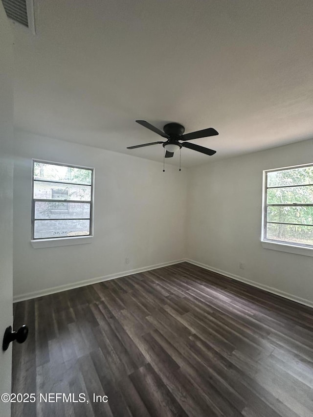 6238 Pettiford Dr W, Jacksonville, FL 32209 - spare room with dark wood-style flooring, baseboards, and ceiling fan