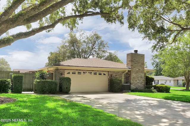 359 Carson Dr, Orange Park, FL 32073 - ranch-style house featuring a chimney, a garage, driveway, and brick siding