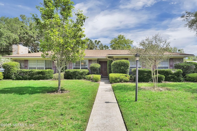 359 Carson Dr, Orange Park, FL 32073 - ranch-style house with a front yard and a chimney