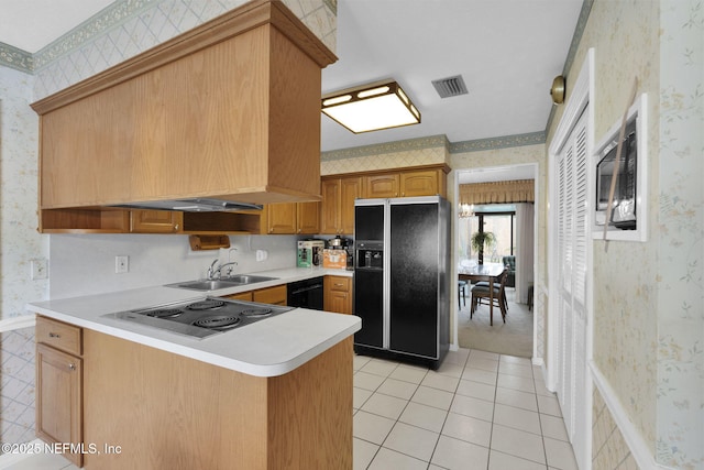 359 Carson Dr, Orange Park, FL 32073 - kitchen with black appliances, wallpapered walls, light tile patterned floors, light countertops, and a peninsula