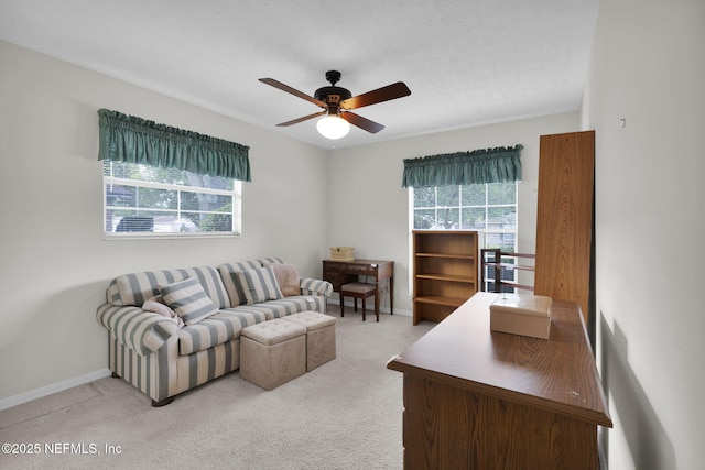 359 Carson Dr, Orange Park, FL 32073 - living area featuring healthy amount of natural light, a ceiling fan, light colored carpet, and baseboards