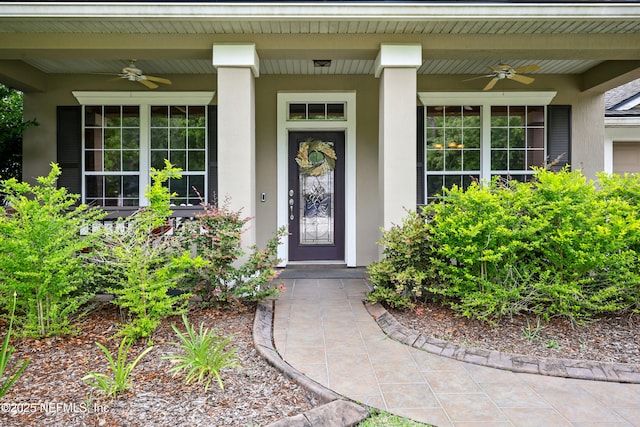 85053 Sagaponack Dr, Fernandina Beach, FL 32034 - view of exterior entry featuring ceiling fan, stucco siding, and covered porch