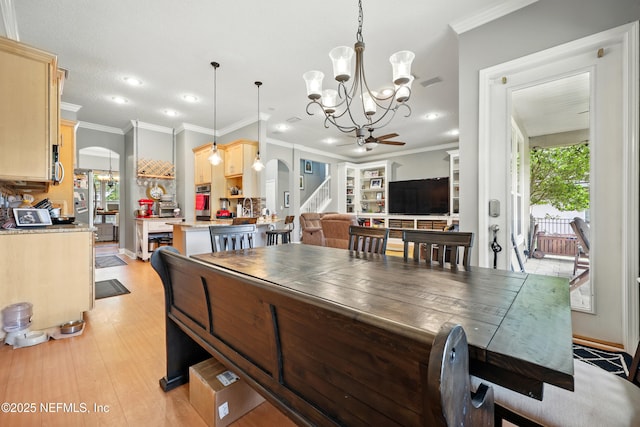 85053 Sagaponack Dr, Fernandina Beach, FL 32034 - dining area with a chandelier, arched walkways, light wood-type flooring, crown molding, and recessed lighting