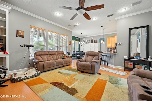 85053 Sagaponack Dr, Fernandina Beach, FL 32034 - living room featuring ceiling fan, a chandelier, a textured ceiling, crown molding, and baseboards