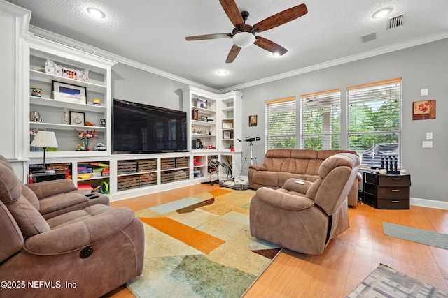 85053 Sagaponack Dr, Fernandina Beach, FL 32034 - living area with a ceiling fan, ornamental molding, a textured ceiling, light wood-style floors, and built in shelves