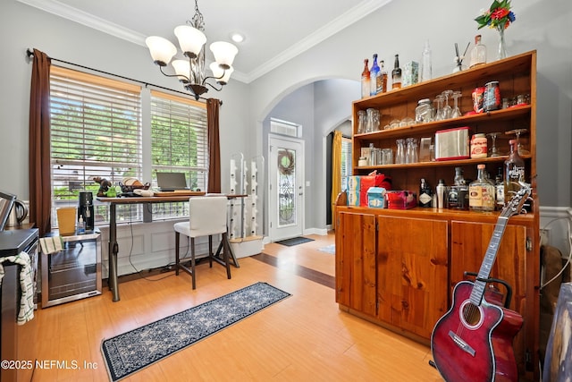 85053 Sagaponack Dr, Fernandina Beach, FL 32034 - bar area featuring crown molding, a chandelier, arched walkways, and wood finished floors