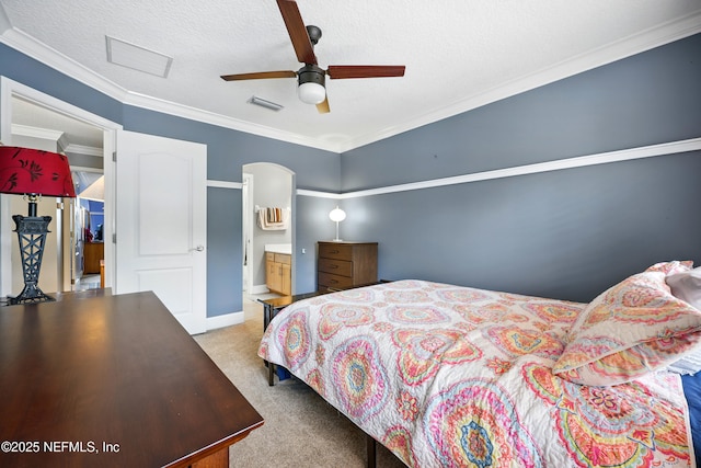 85053 Sagaponack Dr, Fernandina Beach, FL 32034 - carpeted bedroom with arched walkways, a textured ceiling, ceiling fan, crown molding, and ensuite bath