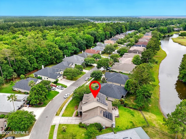 85053 Sagaponack Dr, Fernandina Beach, FL 32034 - aerial view of residential area with a nearby body of water and a heavily wooded area