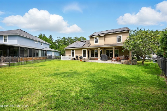 85053 Sagaponack Dr, Fernandina Beach, FL 32034 - back of house featuring a patio area, solar panels, and stucco siding