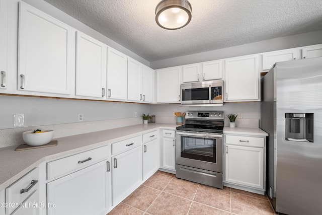1491 Cedar Grove Ter, Fleming Island, FL 32003 - kitchen featuring appliances with stainless steel finishes, light countertops, white cabinetry, and a textured ceiling