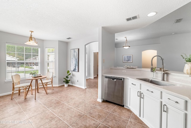 1491 Cedar Grove Ter, Fleming Island, FL 32003 - kitchen featuring stainless steel dishwasher, a sink, arched walkways, a textured ceiling, and light countertops