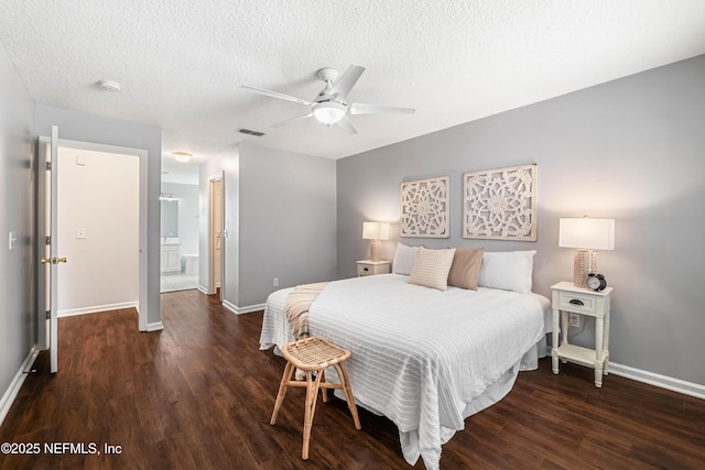 1491 Cedar Grove Ter, Fleming Island, FL 32003 - bedroom with wood finished floors, baseboards, a textured ceiling, ceiling fan, and ensuite bath