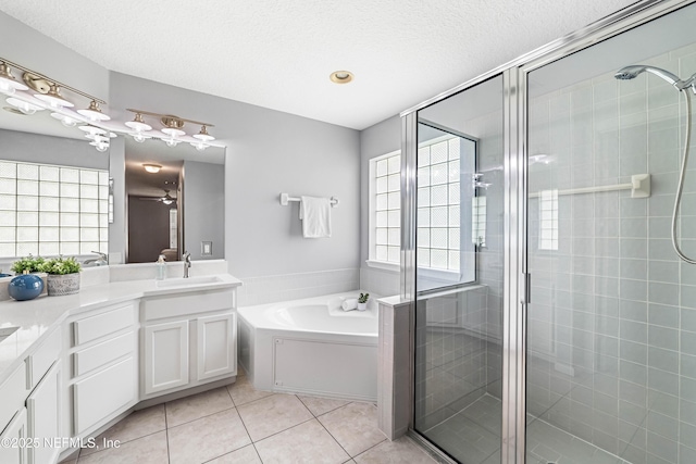 1491 Cedar Grove Ter, Fleming Island, FL 32003 - bathroom with a shower stall, tile patterned flooring, a garden tub, vanity, and a textured ceiling
