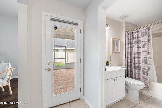 1491 Cedar Grove Ter, Fleming Island, FL 32003 - bathroom with vanity, toilet, shower / bath combo, and tile patterned flooring