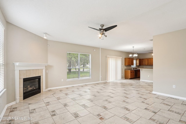 2454 Woodstork Ct, Saint Augustine, FL 32092 - unfurnished living room with a chandelier, ceiling fan, a fireplace, baseboards, and light tile patterned floors