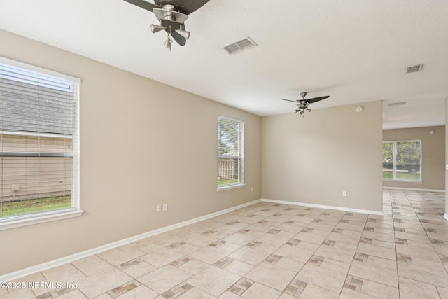 2454 Woodstork Ct, Saint Augustine, FL 32092 - empty room featuring ceiling fan, healthy amount of natural light, and baseboards