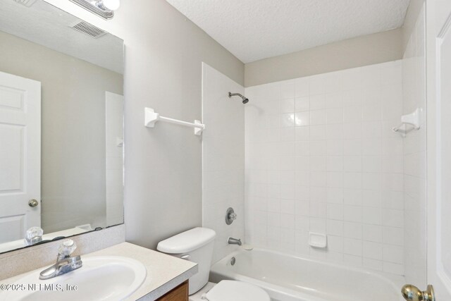 2454 Woodstork Ct, Saint Augustine, FL 32092 - full bath with vanity, toilet, a textured ceiling, and washtub / shower combination