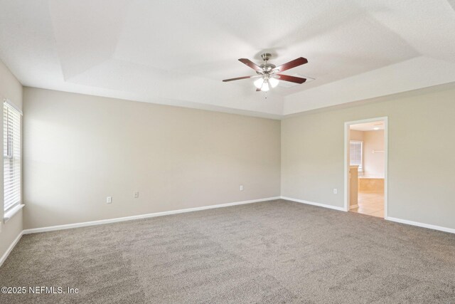 2454 Woodstork Ct, Saint Augustine, FL 32092 - unfurnished room featuring a tray ceiling, ceiling fan, carpet flooring, and baseboards