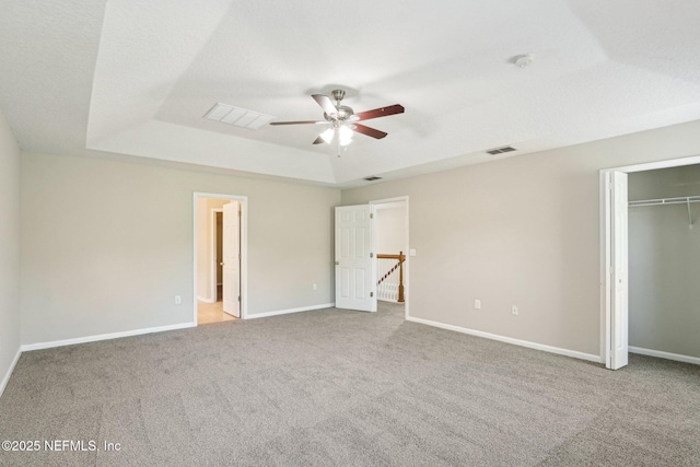 2454 Woodstork Ct, Saint Augustine, FL 32092 - unfurnished bedroom featuring a raised ceiling, carpet floors, baseboards, and ceiling fan