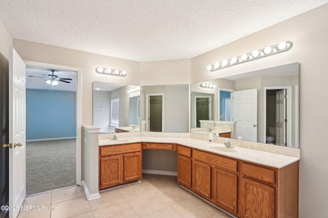 2454 Woodstork Ct, Saint Augustine, FL 32092 - full bath featuring vanity, a textured ceiling, tile patterned floors, ceiling fan, and baseboards