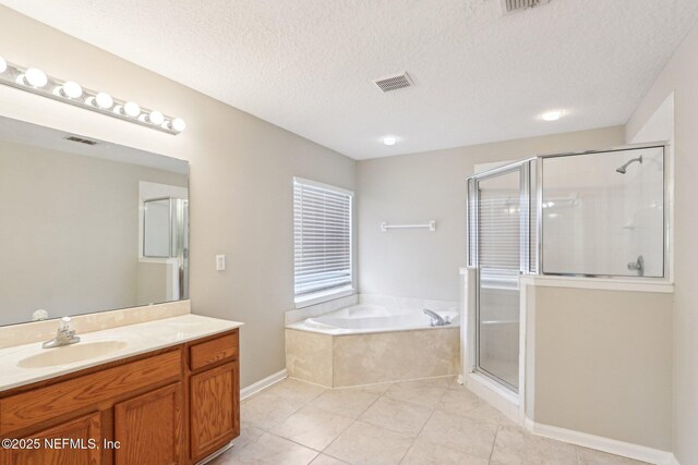 2454 Woodstork Ct, Saint Augustine, FL 32092 - full bathroom featuring tile patterned floors, a stall shower, vanity, a bath, and a textured ceiling