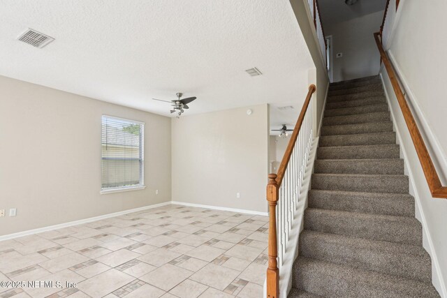 2454 Woodstork Ct, Saint Augustine, FL 32092 - staircase featuring a ceiling fan, a textured ceiling, and baseboards