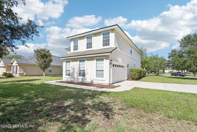 2454 Woodstork Ct, Saint Augustine, FL 32092 - traditional-style house featuring concrete driveway, a front lawn, a garage, and stucco siding
