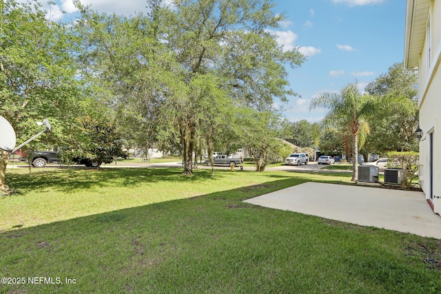 2454 Woodstork Ct, Saint Augustine, FL 32092 - view of green lawn with central AC and a patio area