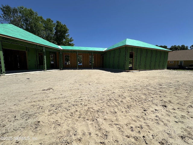 rear view of property featuring board and batten siding