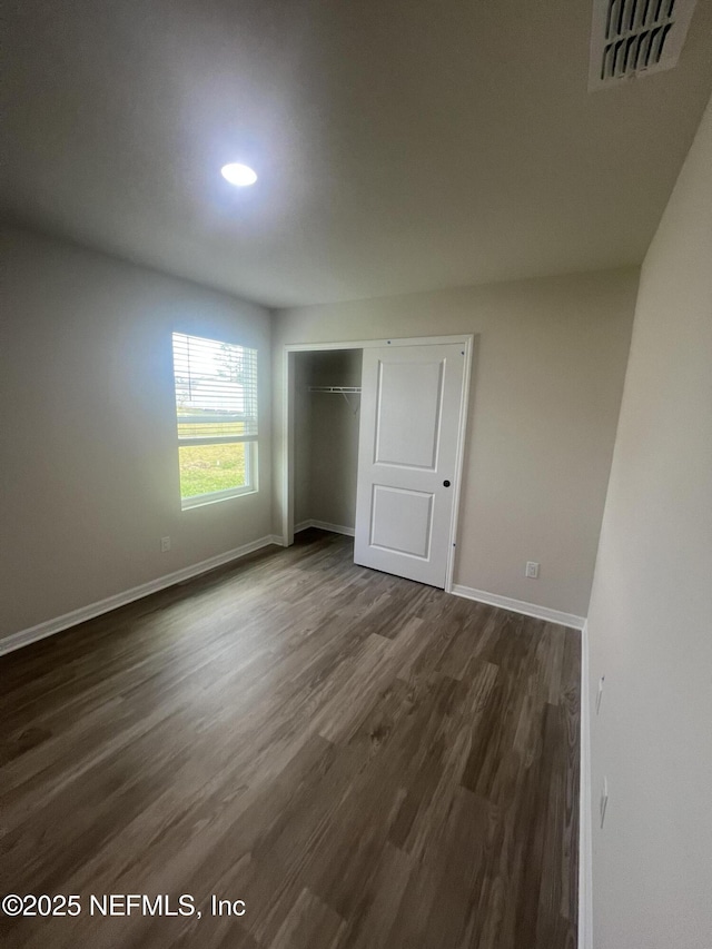 32 Pershing Ln, Palm Coast, FL 32164 - unfurnished bedroom with dark wood-style flooring, baseboards, a closet, and recessed lighting
