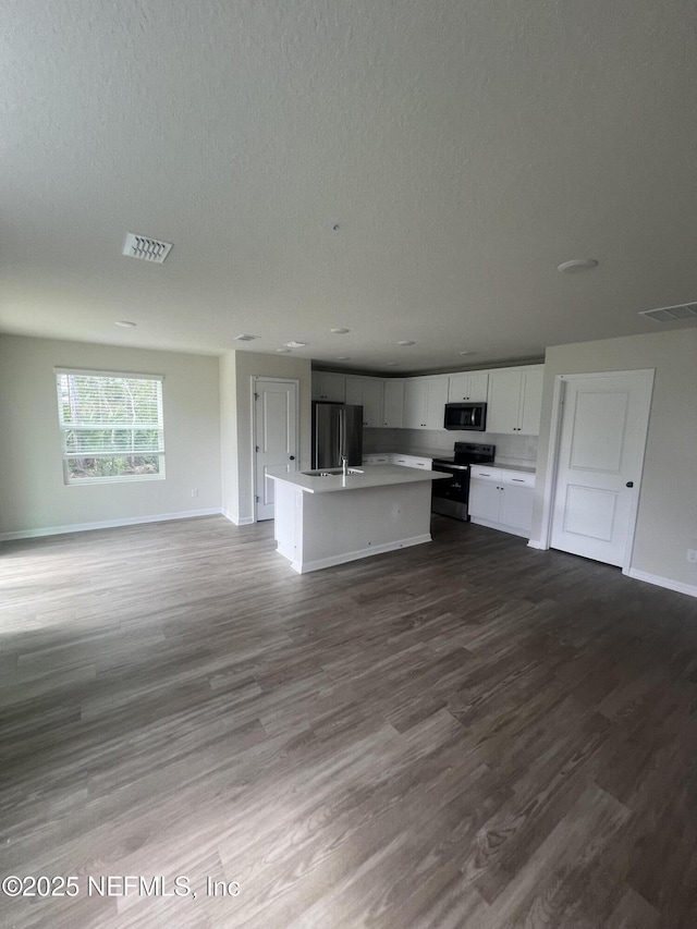 32 Pershing Ln, Palm Coast, FL 32164 - unfurnished living room featuring dark wood-type flooring, baseboards, and a textured ceiling
