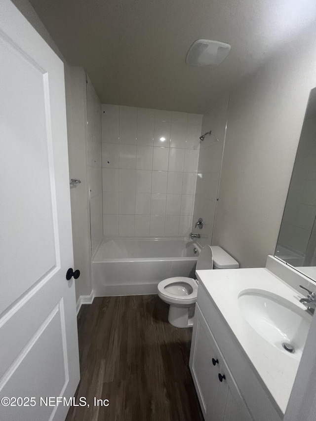 32 Pershing Ln, Palm Coast, FL 32164 - full bath with toilet, wood finished floors, tub / shower combination, and vanity