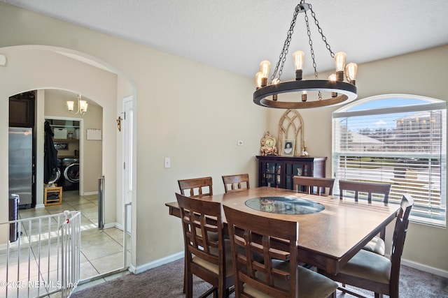 15831 Baxter Creek Dr, Jacksonville, FL 32218 - dining area featuring washer and clothes dryer, a chandelier, healthy amount of natural light, and arched walkways