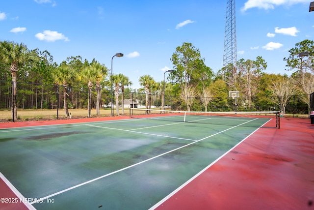 15831 Baxter Creek Dr, Jacksonville, FL 32218 - view of tennis court with community basketball court, fence, and view of scattered trees