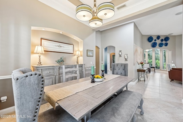 3461 Mainard Branch Ct, Fleming Island, FL 32003 - dining room with arched walkways, baseboards, a chandelier, and light tile patterned flooring
