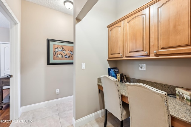 3461 Mainard Branch Ct, Fleming Island, FL 32003 - office area featuring baseboards, built in study area, and light tile patterned floors