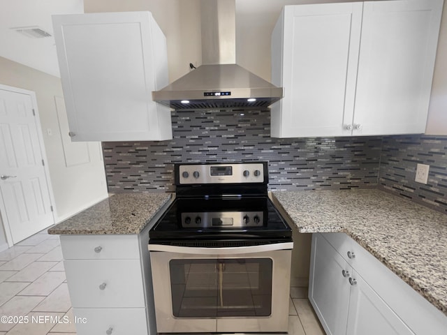 8636 Bermuda Rd, Jacksonville, FL 32208 - kitchen featuring wall chimney exhaust hood, stainless steel range with electric stovetop, tasteful backsplash, and light stone countertops