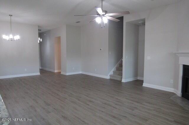 2985 Vianey Pl, Green Cove Springs, FL 32043 - unfurnished living room with wood finished floors, a chandelier, a ceiling fan, and stairway