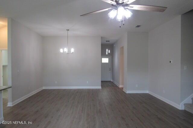 2985 Vianey Pl, Green Cove Springs, FL 32043 - empty room featuring a ceiling fan, wood finished floors, baseboards, a chandelier, and stairway