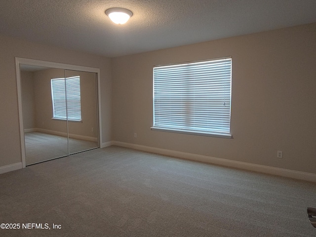 2985 Vianey Pl, Green Cove Springs, FL 32043 - unfurnished bedroom featuring carpet flooring, a closet, a textured ceiling, and baseboards