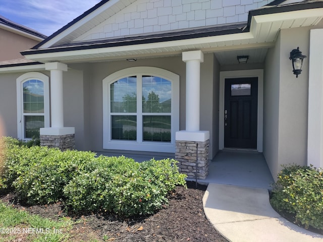 2985 Vianey Pl, Green Cove Springs, FL 32043 - doorway to property featuring stucco siding, covered porch, and stone siding