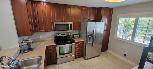 9745 Touchton Rd Unit 1521, Jacksonville, FL 32246 - kitchen with appliances with stainless steel finishes, a sink, light countertops, light tile patterned flooring, and baseboards