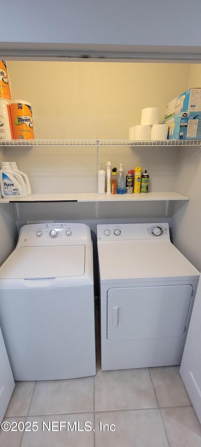 9745 Touchton Rd Unit 1521, Jacksonville, FL 32246 - laundry room featuring washing machine and clothes dryer and light tile patterned flooring