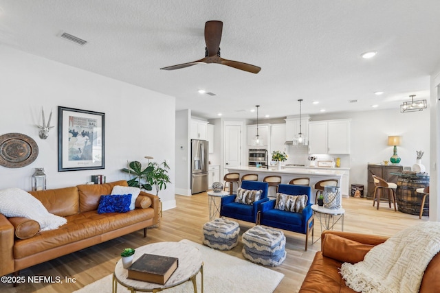 102 Blue Oak Ct, Ponte Vedra, FL 32081 - living area featuring ceiling fan, light wood-type flooring, recessed lighting, and a textured ceiling