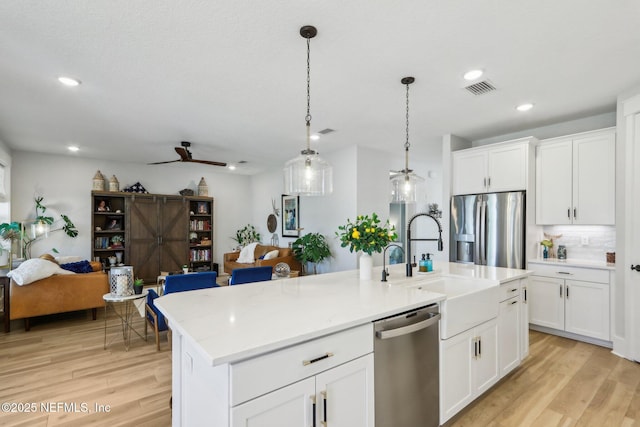 102 Blue Oak Ct, Ponte Vedra, FL 32081 - kitchen with appliances with stainless steel finishes, open floor plan, light wood finished floors, tasteful backsplash, and recessed lighting
