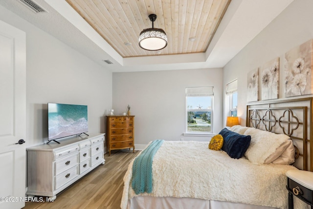 102 Blue Oak Ct, Ponte Vedra, FL 32081 - bedroom featuring a tray ceiling, light wood finished floors, and wooden ceiling