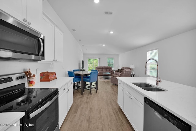 3075 Rustic Deer Way, Green Cove Springs, FL 32043 - kitchen featuring stainless steel appliances, light wood-style floors, white cabinets, recessed lighting, and light stone countertops