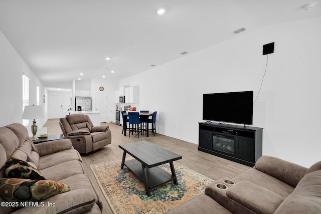 3075 Rustic Deer Way, Green Cove Springs, FL 32043 - living room with vaulted ceiling, recessed lighting, and light wood finished floors
